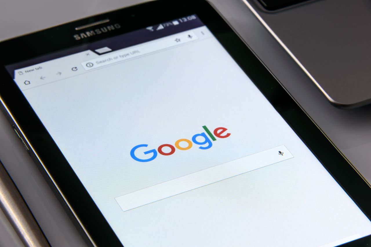 services-05 Close-up of a tablet displaying Googles search screen, emphasizing technology and internet browsing.